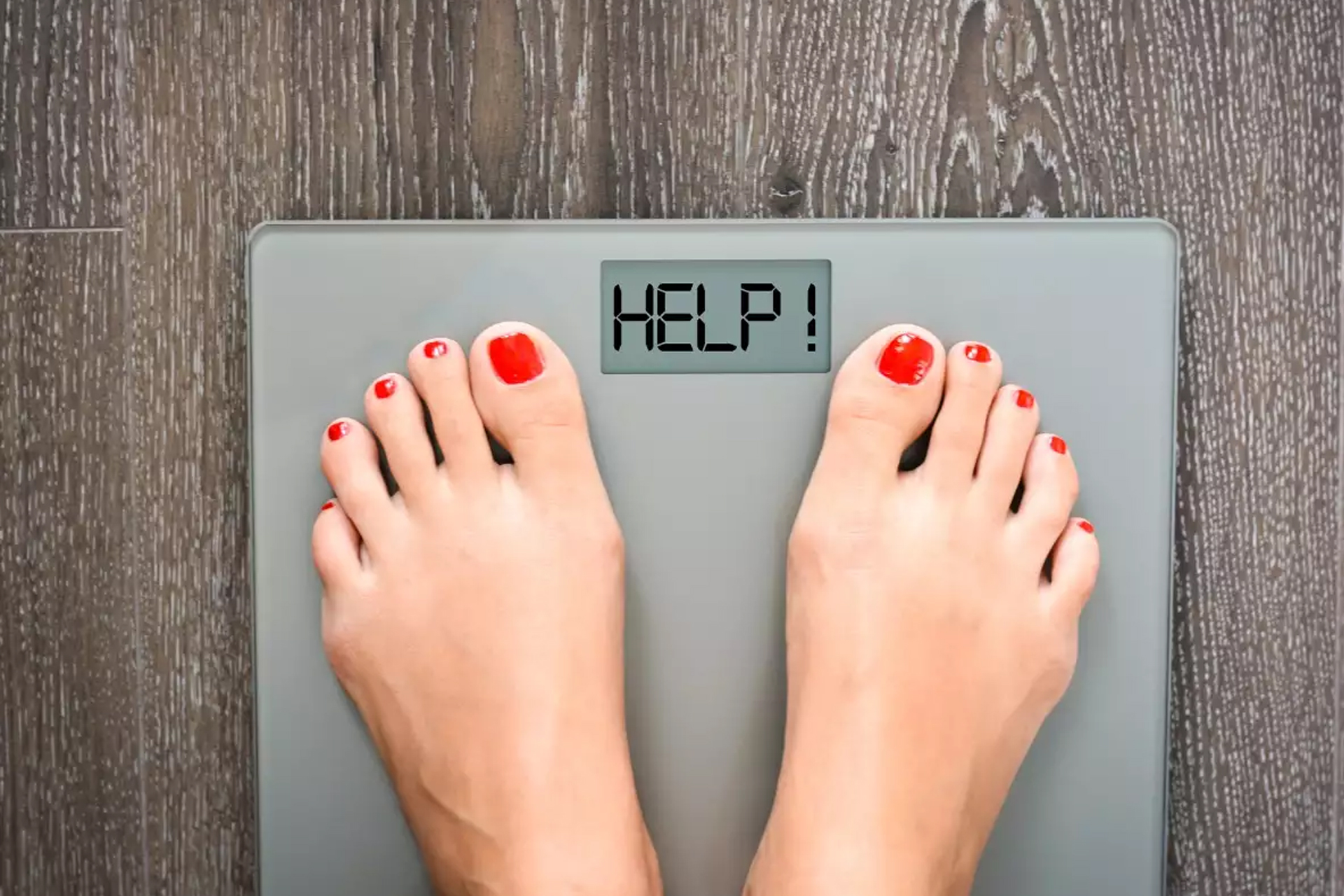 Close-up of feet on a weighing scale — symbolizing the rising obesity rates in Ghana