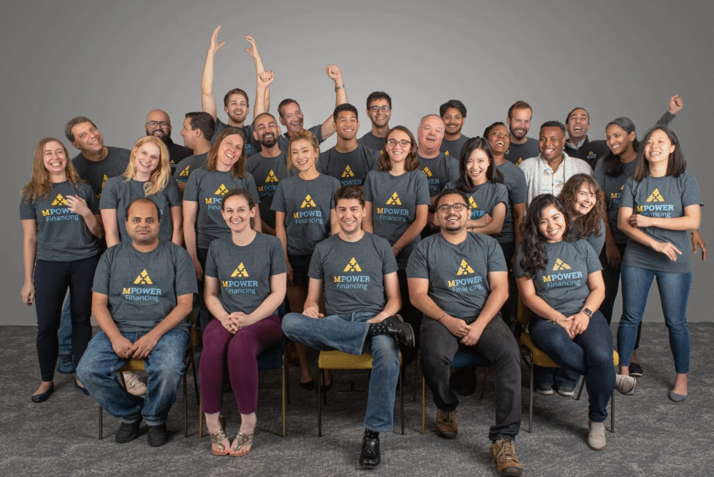 Mpower group photo showcasing a diverse team supporting students with financial empowerment and education initiatives in Ghana.
