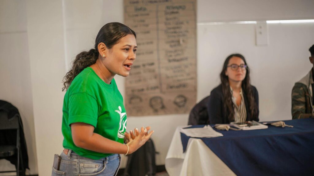 Young African leader speaking at a community event.