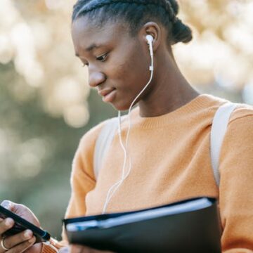 Ghanaian using headset to reduce mobile phone hazards
