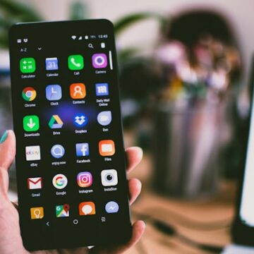 Smartphone screen displaying popular social media apps like Facebook, Instagram, Twitter, and TikTok.