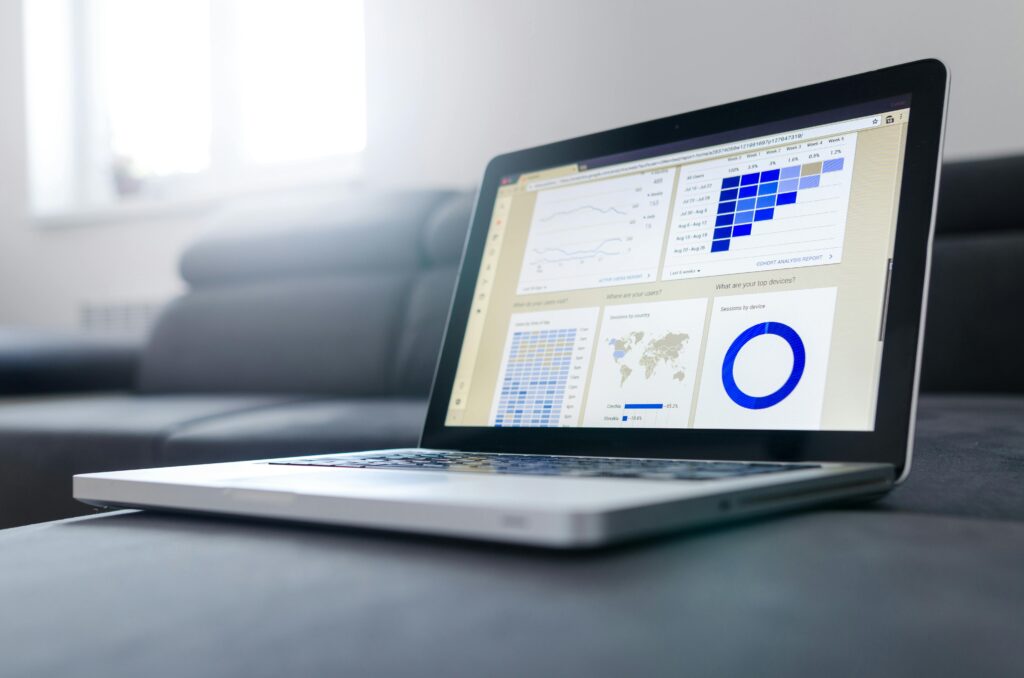 Freelancer creating digital marketing content on a laptop, with charts and graphics on the screen.
