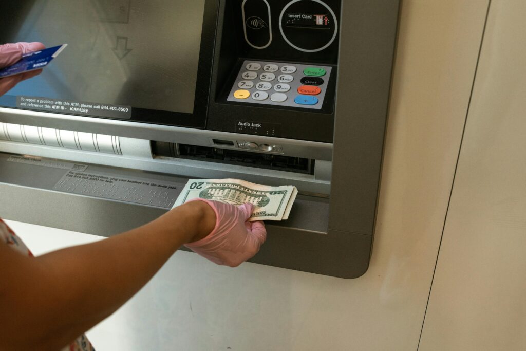 ATM located in a well-lit area with a visible surveillance camera for physical security