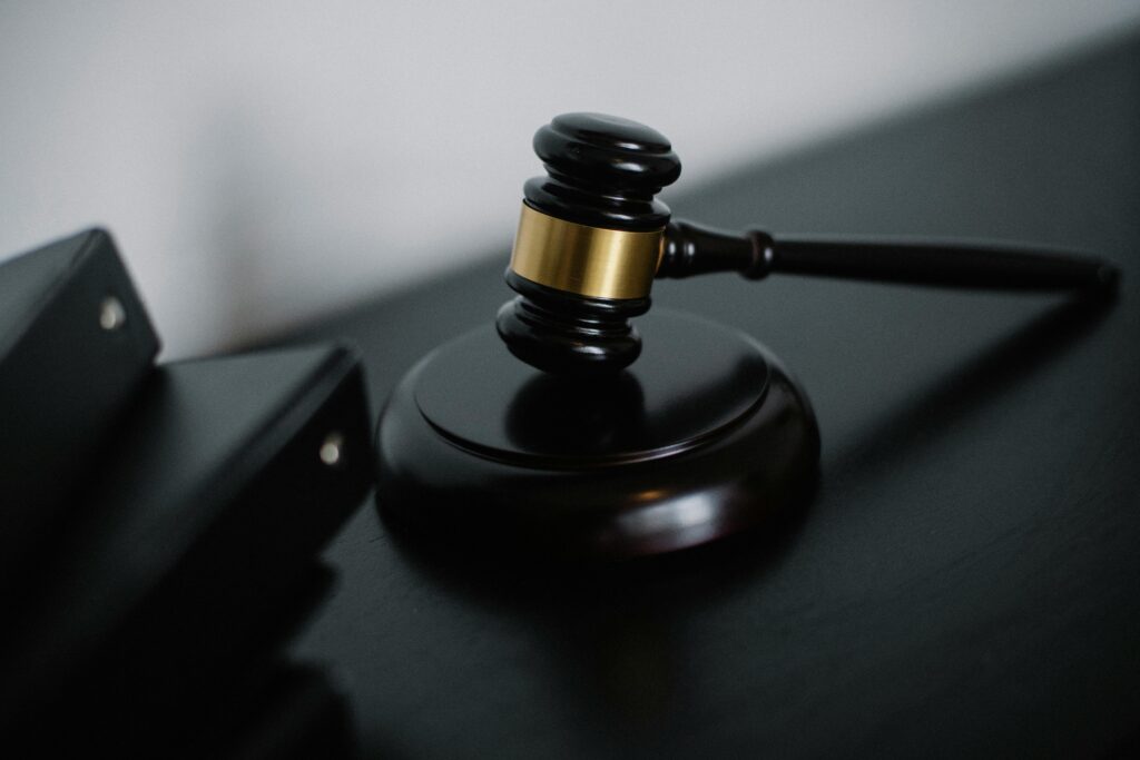 A judge’s gavel and law book symbolizing Ghana’s unpassed competition law.