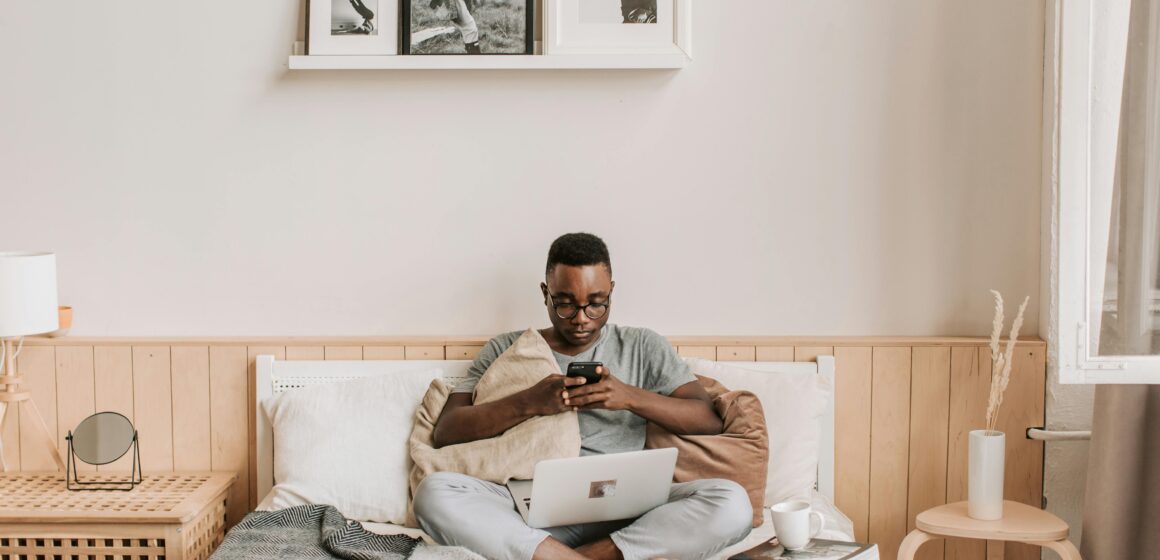 A young Ghanaian professional working remotely on a laptop at home with stable internet access.