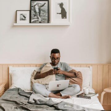 A young Ghanaian professional working remotely on a laptop at home with stable internet access.